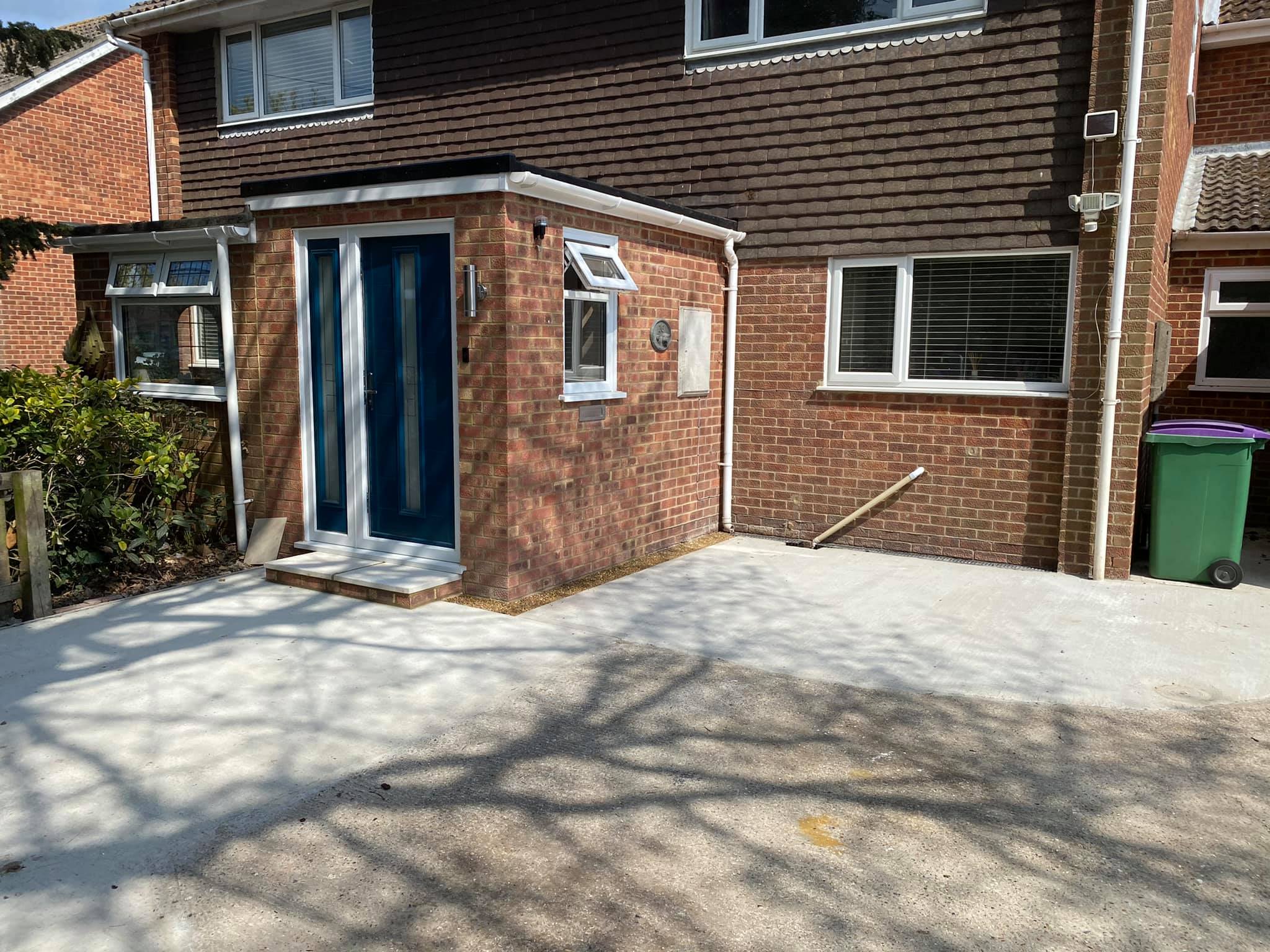 New brick-built porch with a blue front door