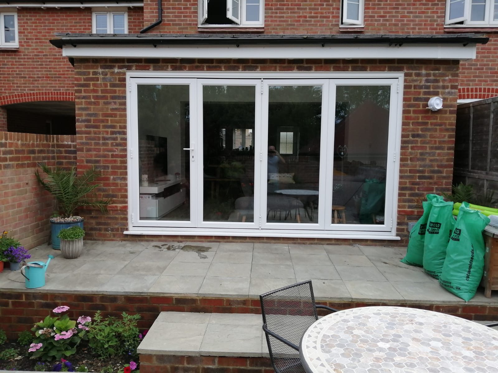 Rear extension with white bifold doors and a new patio