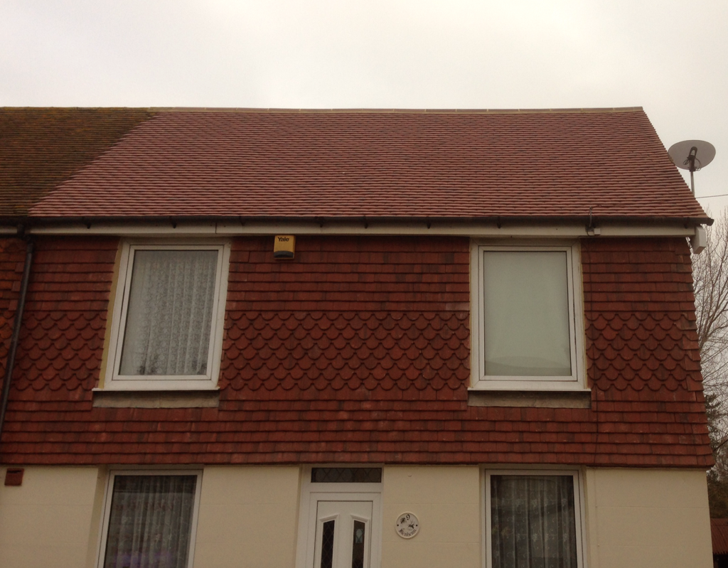 Re-tiled roof and tile-hung upper wall on a home in Kent