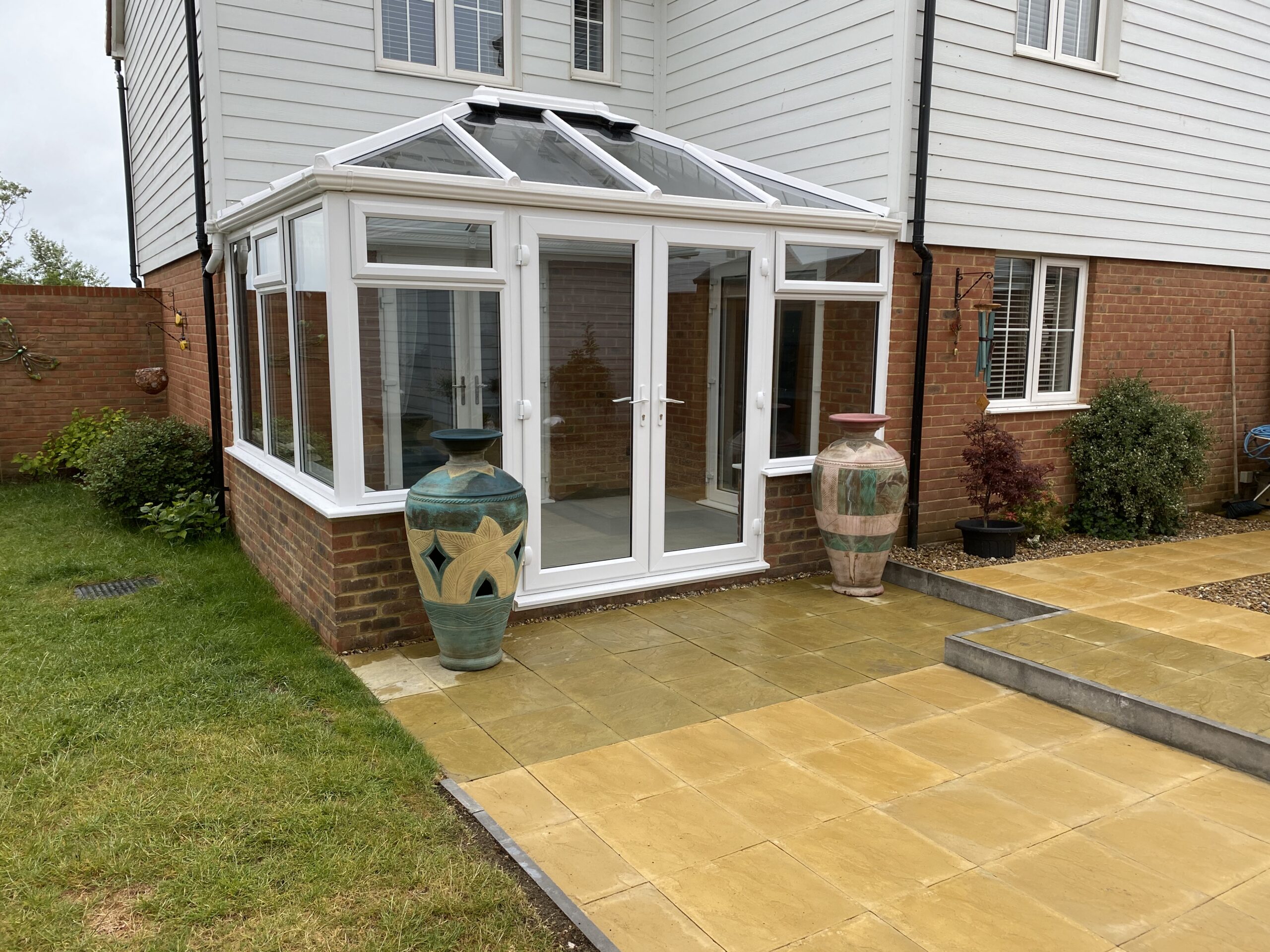White uPVC conservatory with a glass roof built by J Burgoyne Limited